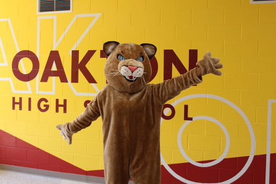 Cougar in front of gold mural