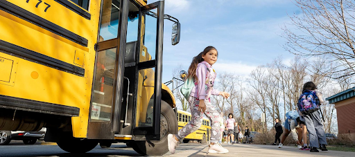 student getting off of the school bus