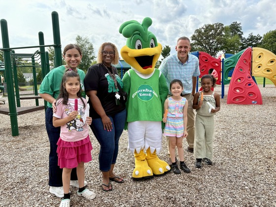 Greenbriar East’s administrative team poses with three students and the school mascot on the playground during the Kindergarten event. 