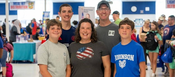 family smiles for a photo