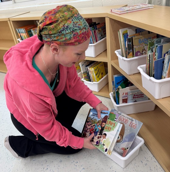 Teacher organizing books