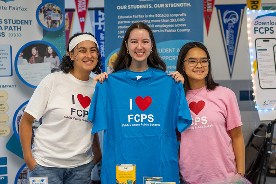 Three teen girls show off I heart FCPS shirts.