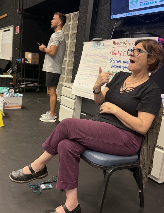 photo of ASL interpreting at a staff meeting