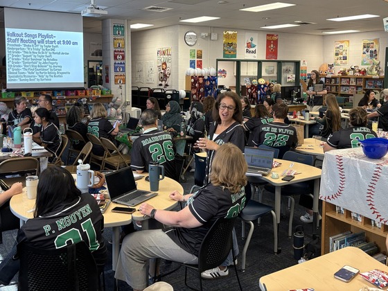 Greenbriar East staff members gather in the library for a baseball-themed back-to-school staff meeting.