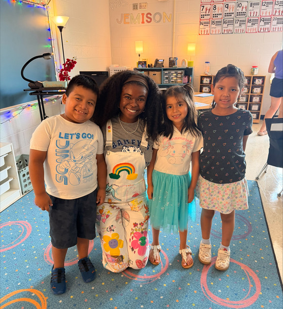 Ms. Jemison with 3 students at Open House
