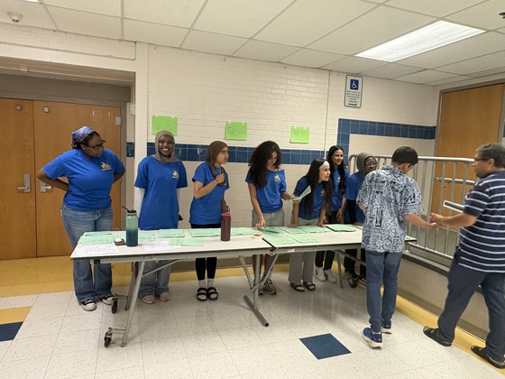 Students passing out student schedules.