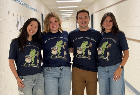 Third grade team wearing matching shirts featuring a frog on a scooter