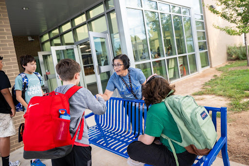 teacher greets students on the first day of school