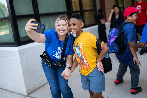 teacher takes a selfie with a student