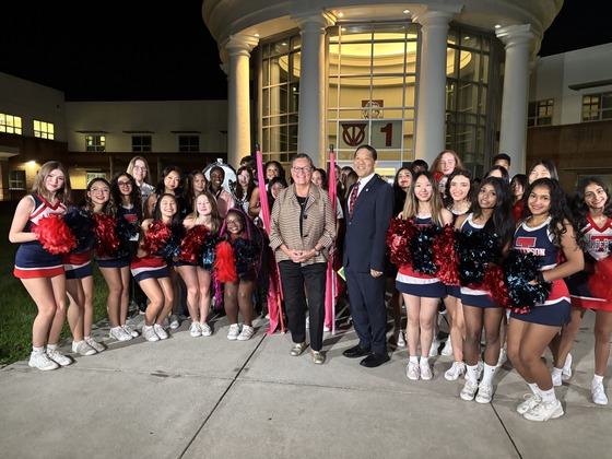 Dr. Reid and Mike Mukai pose in front of school with several TJ students as part of WJLA's morning coverage.