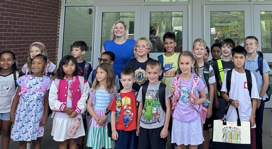Photo of students and principal on first day of school