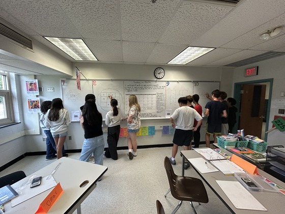 students working at board on math