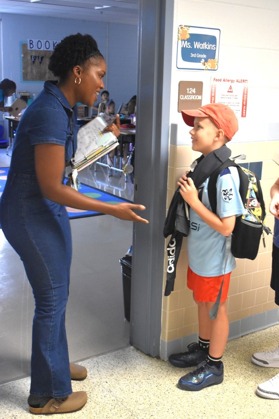 Ms. Watkins greeting a student