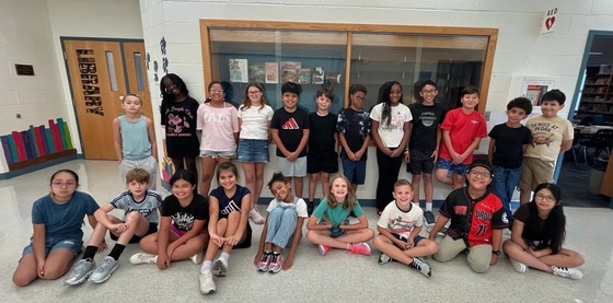 Mrs. Lopes' 5th grade class posing in front of the Library