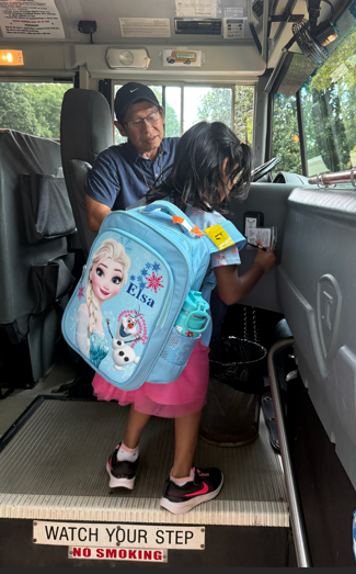 Kindergarten student tapping on to the bus