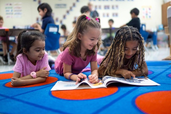 three young students reading together