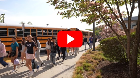 image of students getting off the bus at school with a youtube play button on it