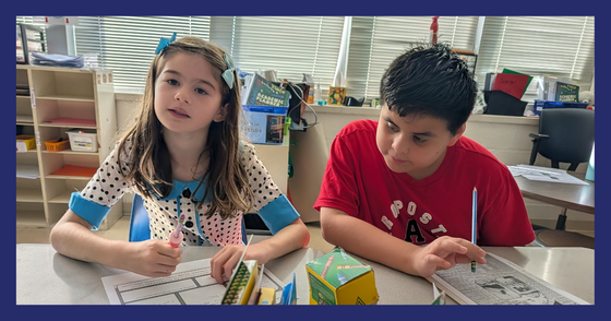 Two students sit next to each other. One has a primary source document and one has a notes paper.