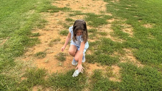 student picking up trash on school grounds
