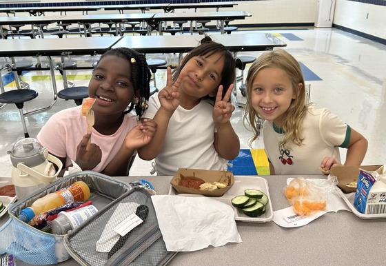 3 girls eating lunch on the cafeteria at HMES