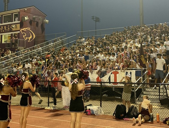 cheerleaders in front of the student section at the football game