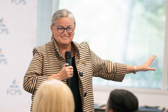 Superintendent Reid speaks into a microphone