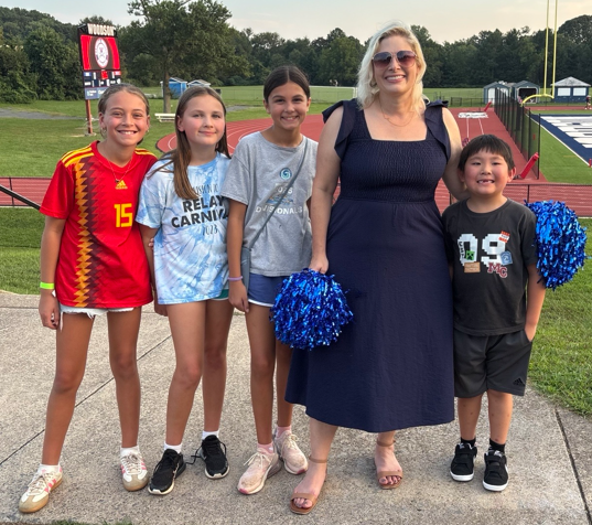 picture of principal with students at Woodson pyramid feeder night