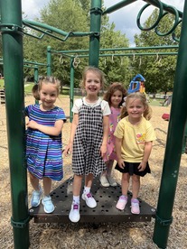 Four students standing on the playground