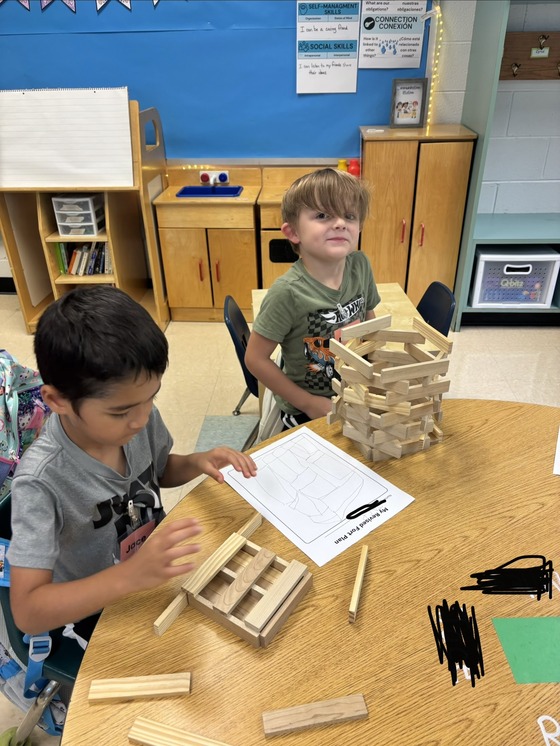 Kindergarten students building with KEVA Planks