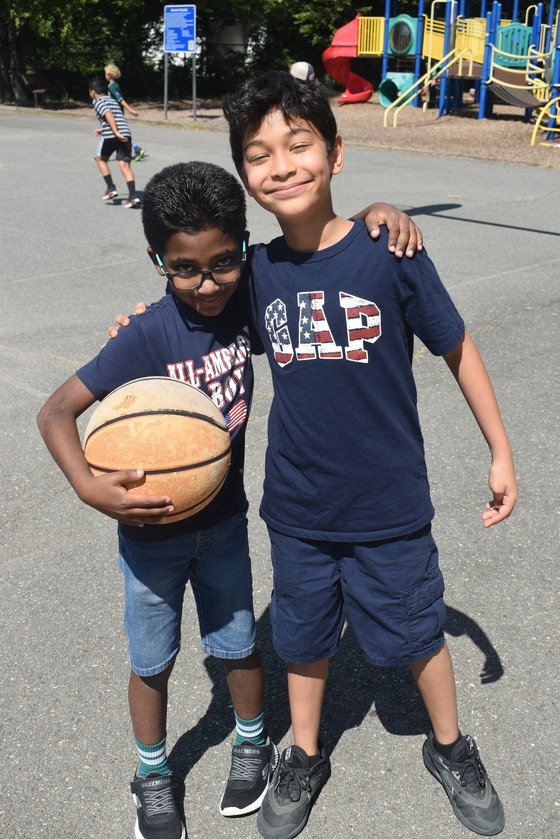 Two friends playing basketball at recess