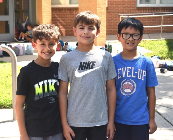 3 male students posing for the camera at recess