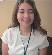 Photo of Mrs. Fitzmorris, smiling with long curly brown hair