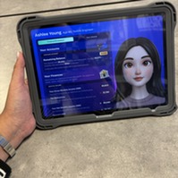 Hand holding a tablet featuring a screen with a lifestyle profile for a participant at Junior Achievement Finance Park.