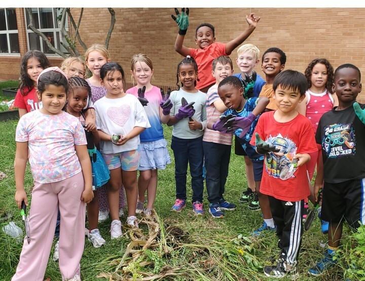 2nd grade students getting ready to weed in the garden