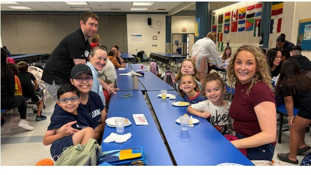 1st grade families enjoying breakfast at Breakfast Bites event