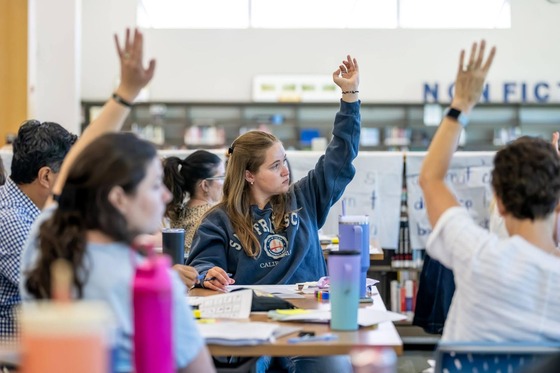 student raising their hand