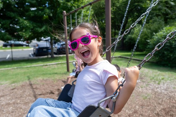student on a swing at the playground
