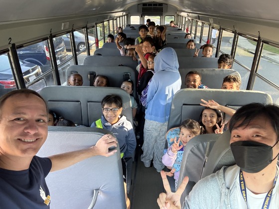 Students on the bus ready for their ride to school.