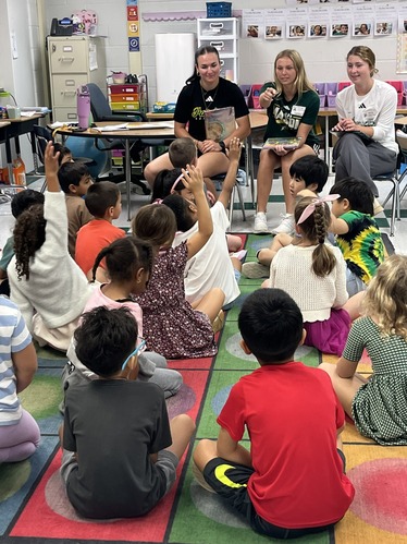 GMU Softball Players read to first grade students
