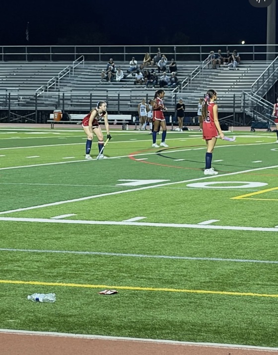 Girls playing field hockey