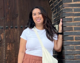 Woman standing near a brick wall