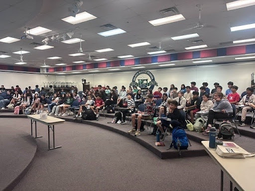 Students sitting in an auditorium listening to an info session for STEM related clubs