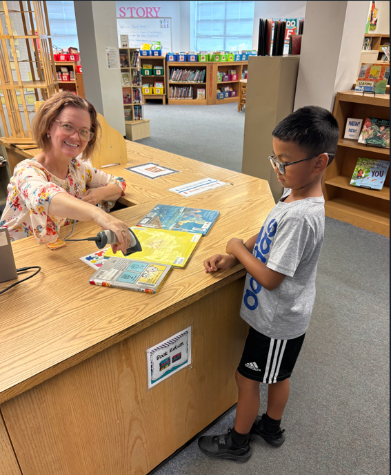 Student checking out library books