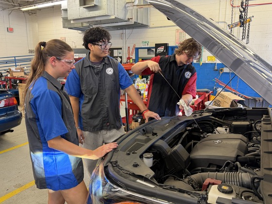 Students doing an oil change