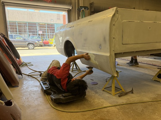 Auto Collision students sanding a truck bed