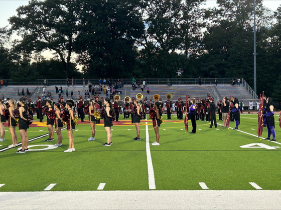 band cheer and dance on the field for game