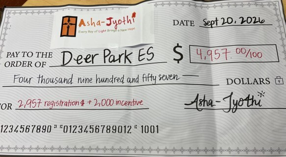 Asha jyothi donation check in the amount of $4,957