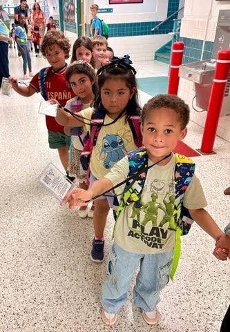 students holding up their ID badges