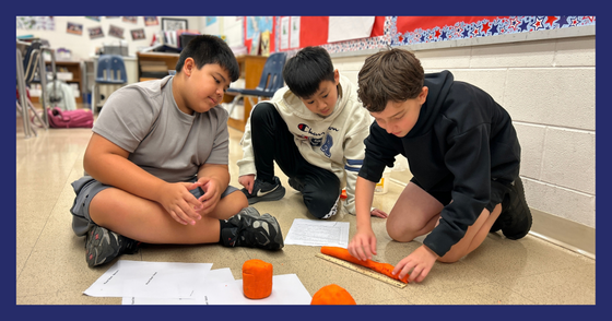 Three students separate a container of orange play dough into multiple pieces.