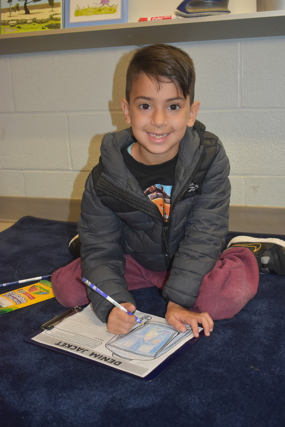 A picture of a student coloring in a book